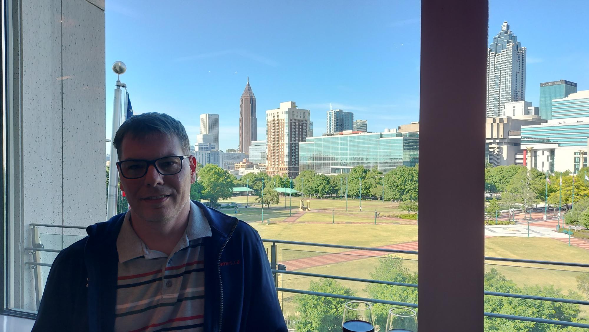 Shawn-hanging-out-at-the-conference-with-the-Atlanta-Skyline