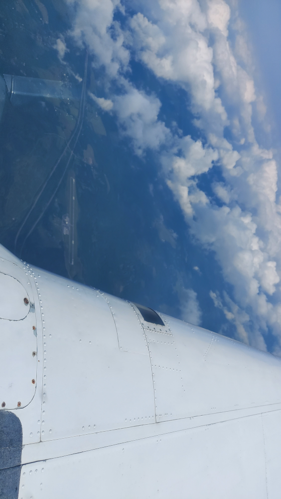 An-airport-visible-through-a-hole-in-the-clouds