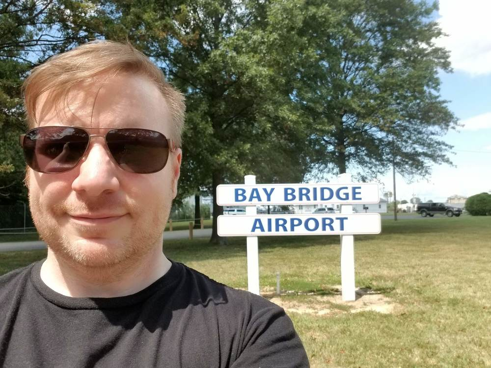 Zack-selfie-with-the-Bay-Bridge-airport-sign-A-new