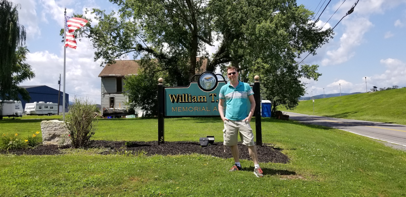 Shawn-standing-in-front-of-the-sign-at-Lock-Haven